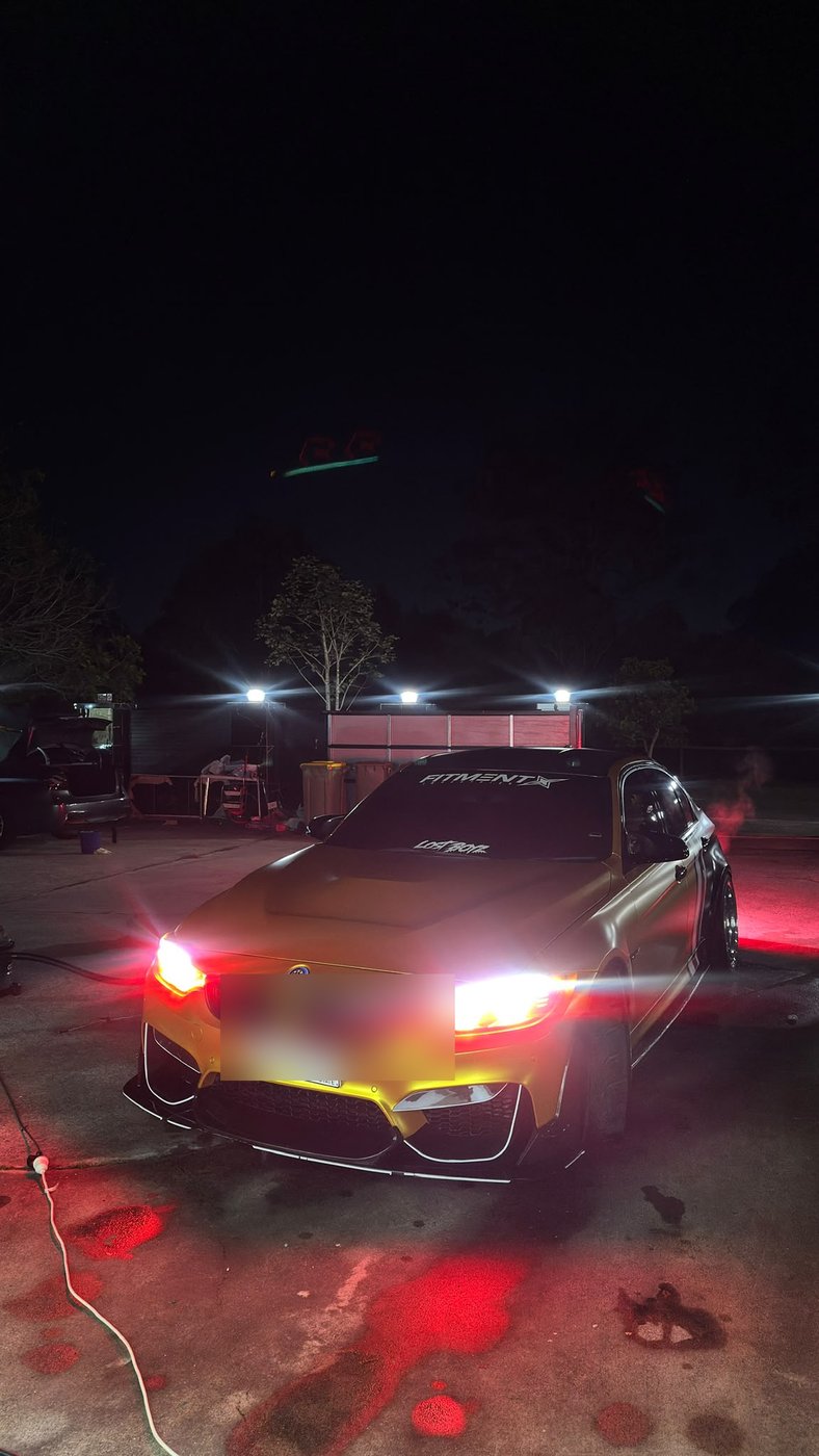 Sports coupe after an evening detail under work lights