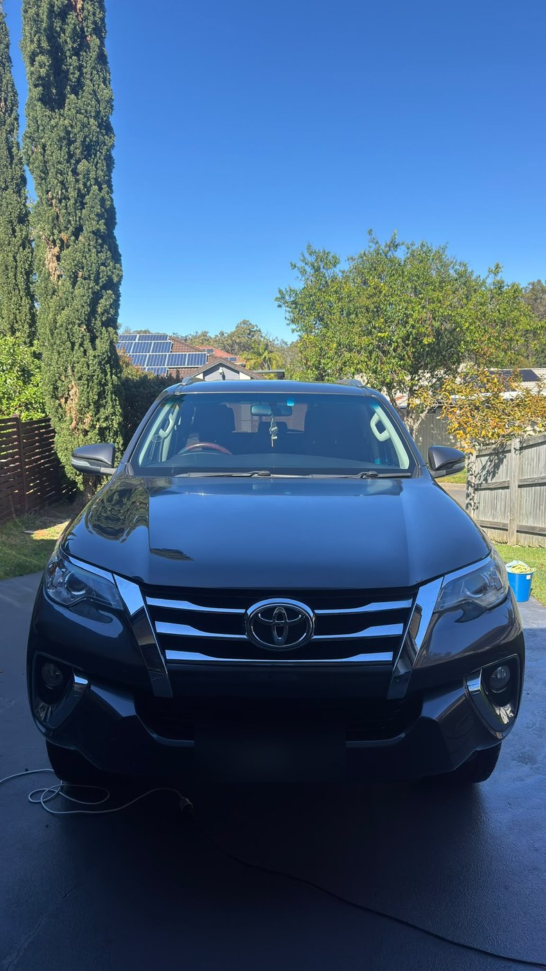 Dark SUV detailed in a driveway